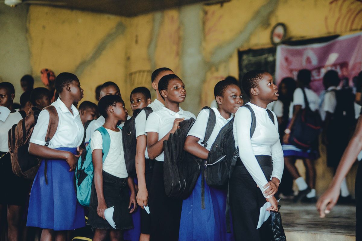 Schoolchildren lining up with their backpacks