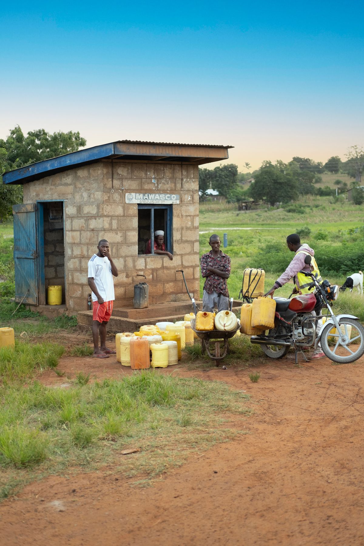 Families gather at a rural water supply station